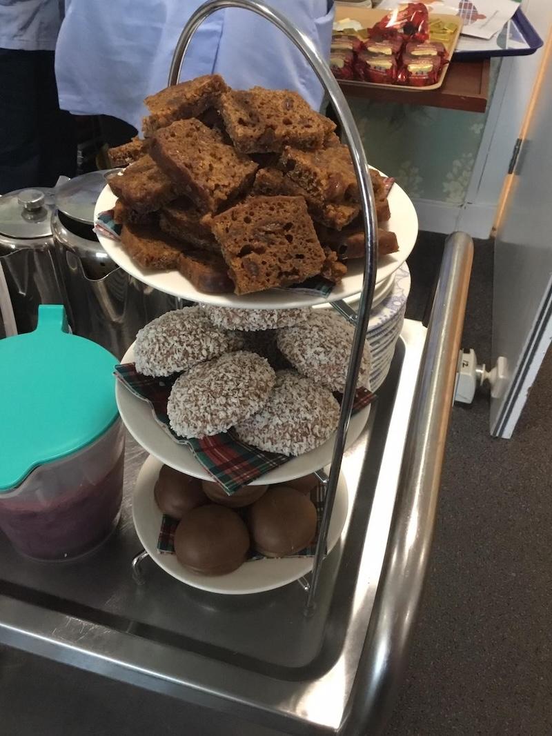 Cake and coconut covered chocolate on a stand
