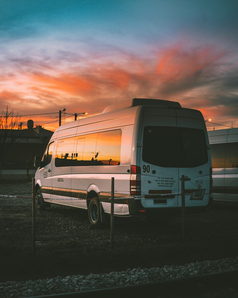 minibus in car park with sunset
