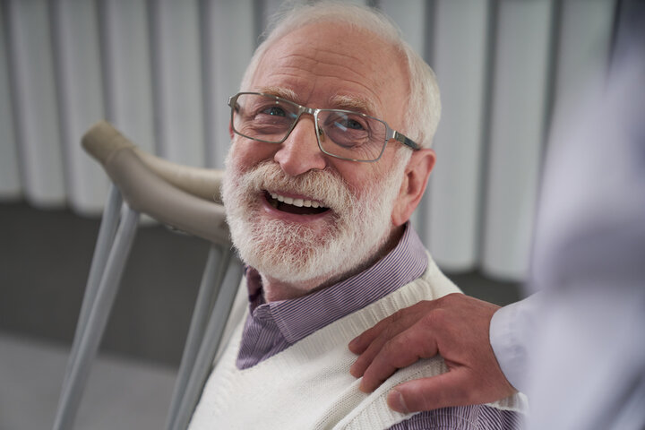 Elderly patient looking thankful for his doctors care