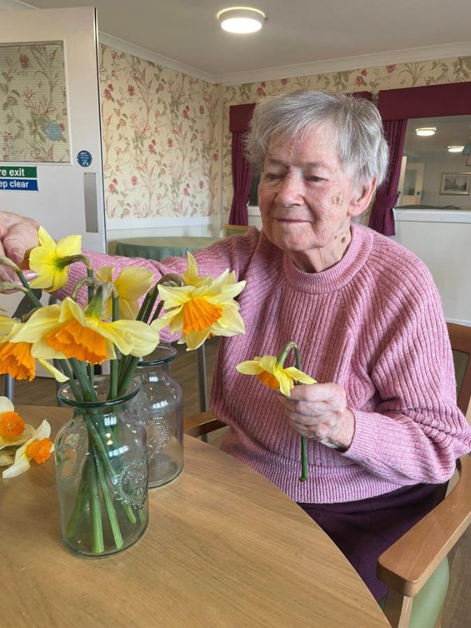 resident arranging easter flowers