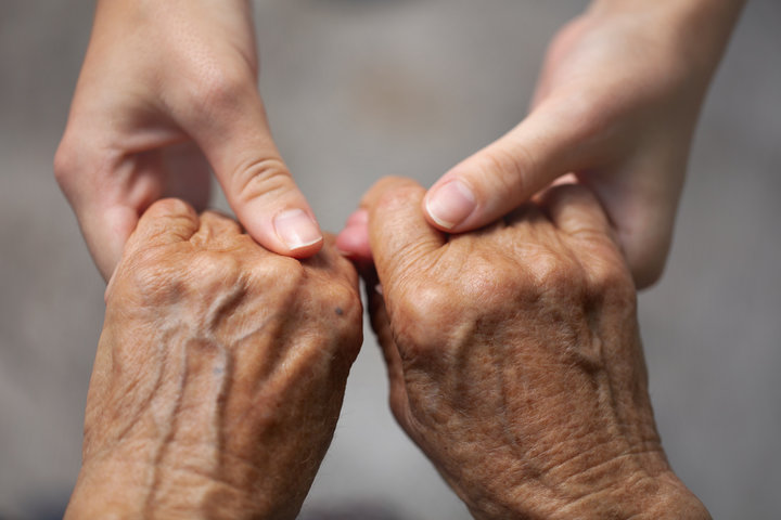older-person-hands-holding-carers-hand-close-up