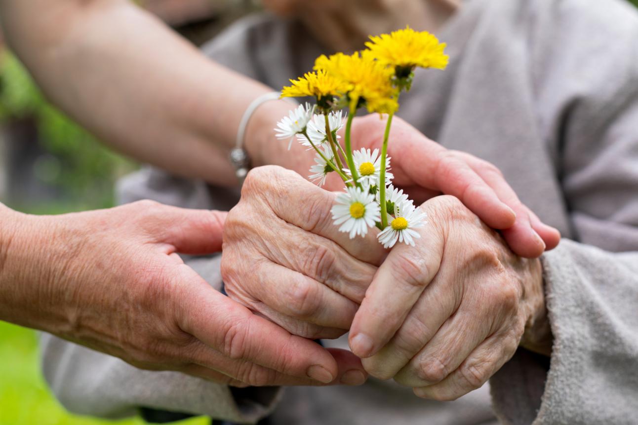 Older-woman-holding-flowers
