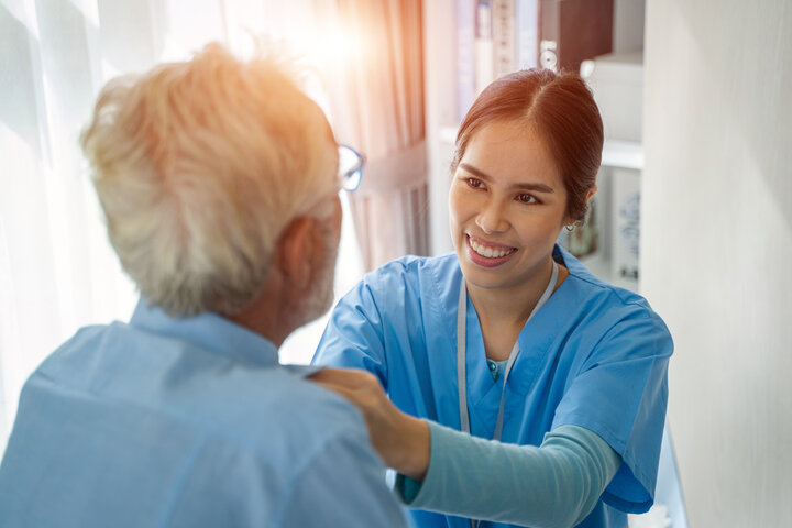 nurse helping resident get dressed